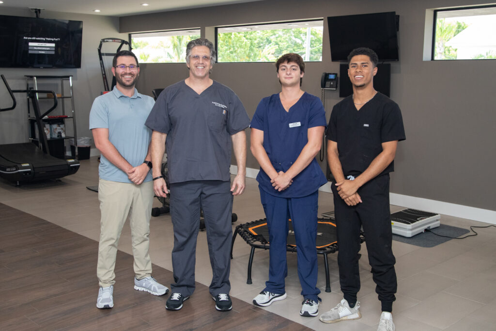 Dr. Miller posing with his staff