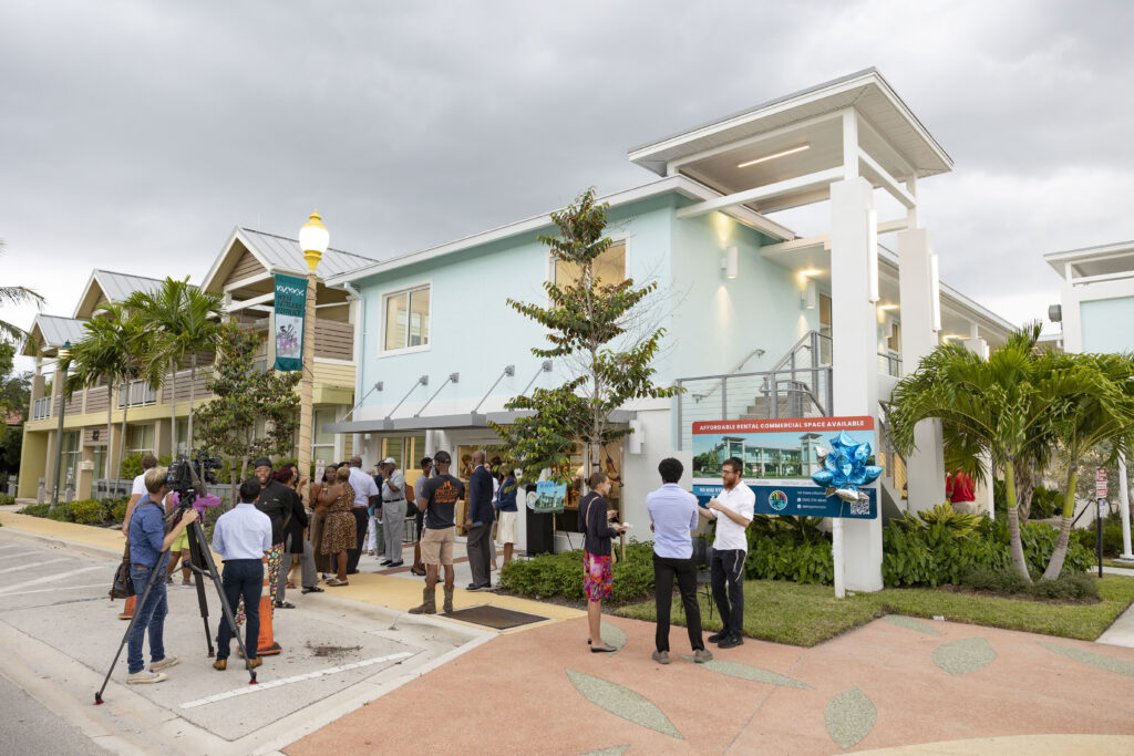 The exterior of the 98 NW 5th Ave building with guests socializing in front