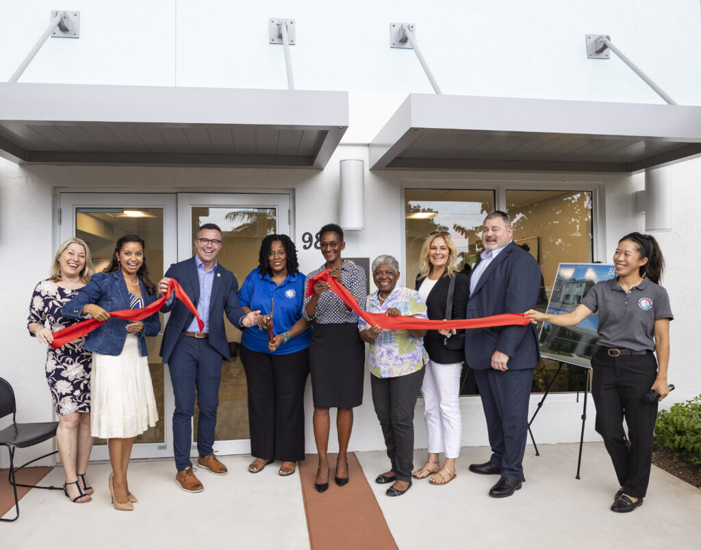 Delray Beach CRA staff, board members and commissioners posing for a photo at the 98 NW 5th Avenue Project ribbon cutting